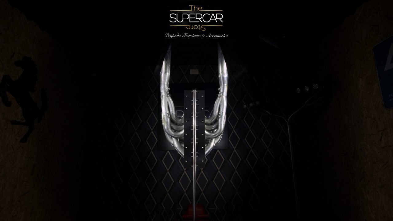 The Final Lap — Ayrton Senna McLaren MP4/6 exhaust sculpture, side view showing 12-pipe V12 arrangement on carbon fibre plinth